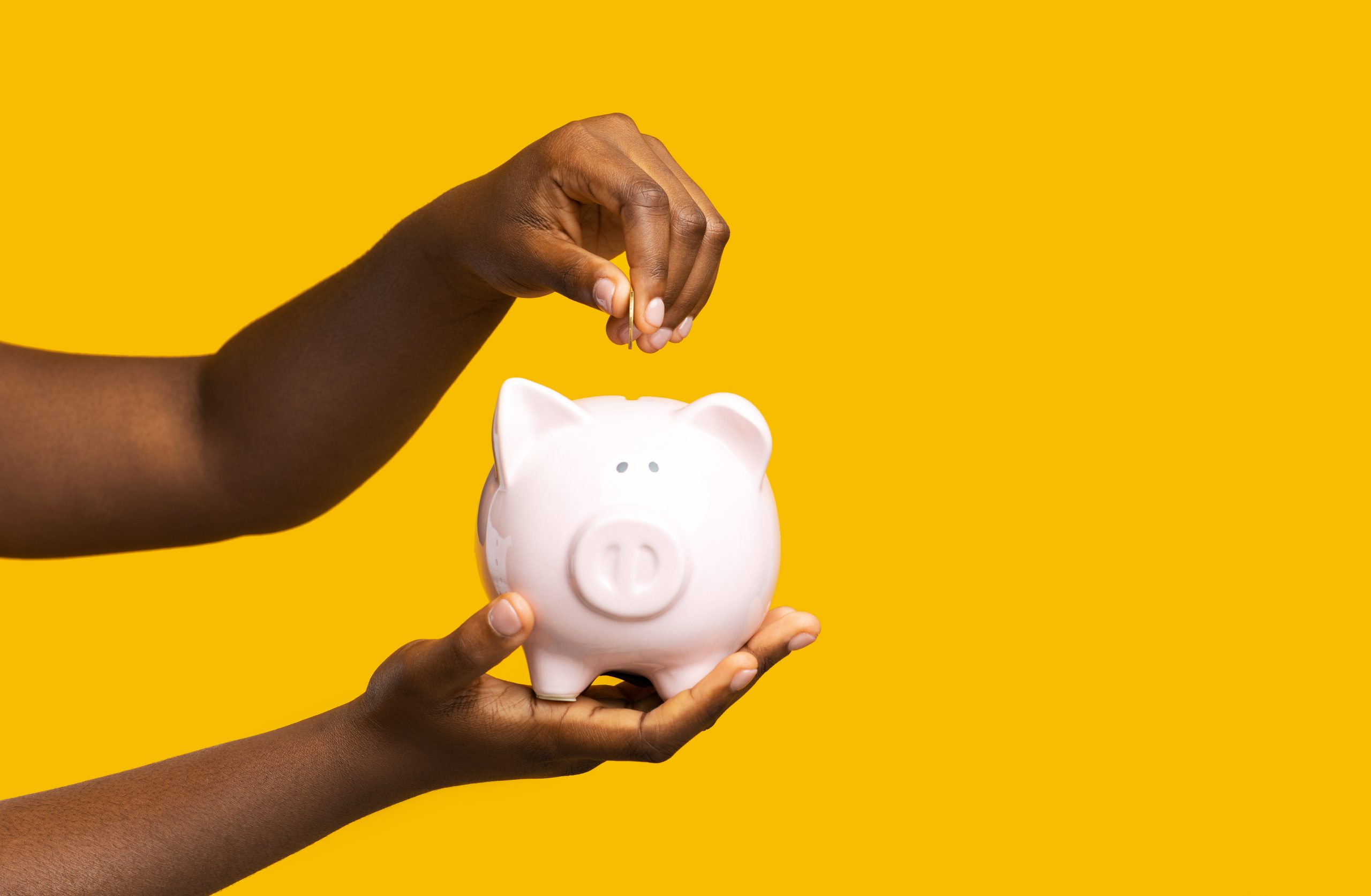 Money,Savings.,Unrecognizable,Black,Woman,Putting,Coin,Into,Ceramic,Piggy - savings and current account